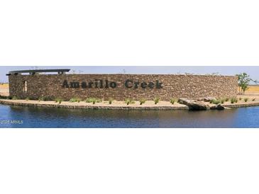 Amarillo Creek community entrance with stonework and water feature at 47748 W Kenner Dr, Maricopa, AZ 85139