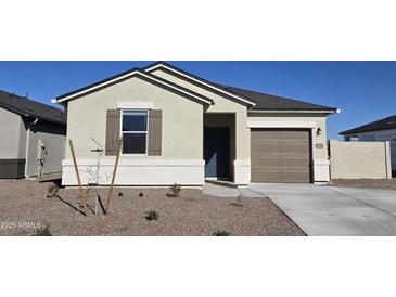 Single-story house with neutral siding, brown garage door, and small front yard at 5484 E Rock Bush Ln, San Tan Valley, AZ 85140