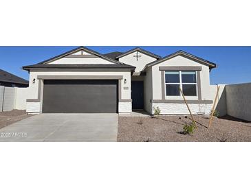 White and gray one-story house with a two-car garage and a small front yard at 5596 E Arctic Ln, San Tan Valley, AZ 85140