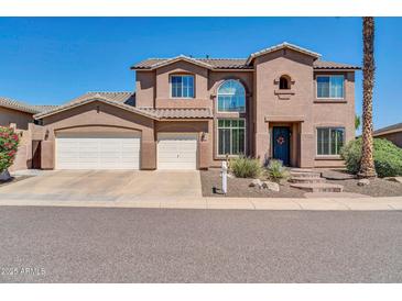 Two-story house with a three-car garage and a walkway leading to the entrance at 6618 W Red Fox Rd, Phoenix, AZ 85083