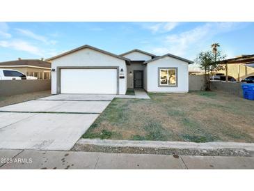 Newly constructed single-story home with a two-car garage and front yard at 6638 S 6Th Ave, Phoenix, AZ 85041