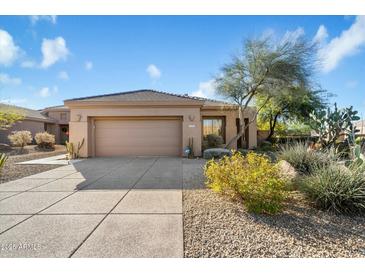 Single-story home with a two-car garage and desert landscaping at 7105 E Hibiscus Way, Scottsdale, AZ 85266