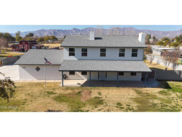 Two-story house with covered patio, large yard, and mountain views at 7528 N 185Th Ave, Waddell, AZ 85355