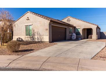 Single-story house with a two-car garage and desert landscaping at 910 W Prior Ave, Coolidge, AZ 85128