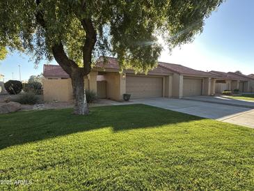 Cute stucco home with 2-car garage and well-manicured lawn at 945 N Pasadena St # 113, Mesa, AZ 85201