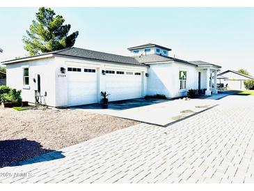 Modern home exterior with paver driveway at 17234 N 28Th St, Phoenix, AZ 85032