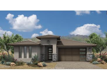 Modern Prairie-style home with a two-car garage and desert landscaping at 21435 W Meadowbrook Ave, Buckeye, AZ 85396