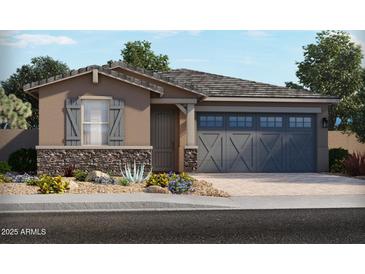 One-story home with gray garage doors and stone accents at 24344 W Graham Trl, Buckeye, AZ 85326