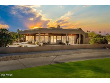 Luxury home with stucco exterior, covered patio, and stunning sunset views at 25633 N Abajo Dr, Rio Verde, AZ 85263