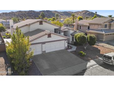 Two-story house with three-car garage and desert landscaping at 2705 E Verbena Dr, Phoenix, AZ 85048