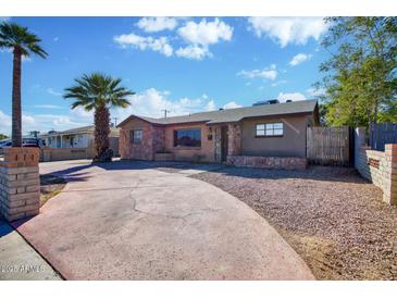 Cute ranch home with a large driveway and mature palm tree at 2733 W Alice W Ave, Phoenix, AZ 85051