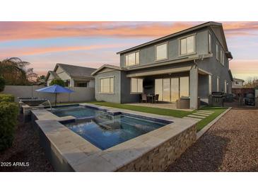 Stunning backyard oasis featuring a sparkling pool and spacious patio at 3045 E Bloomfield Pkwy, Gilbert, AZ 85296