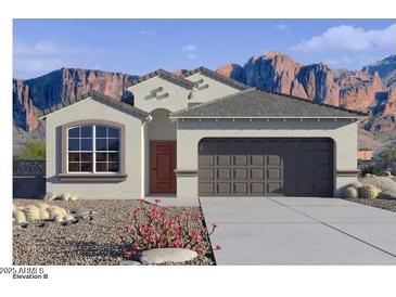 One-story house with brown garage door and red front door, desert landscaping at 4930 S 105Th Ln, Tolleson, AZ 85353