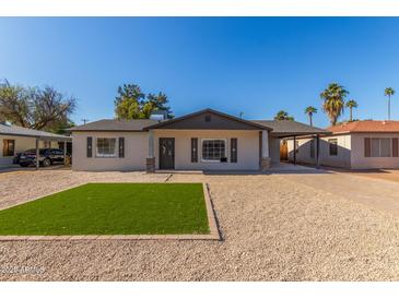 Newly renovated single story home with artificial turf lawn and updated landscaping at 1018 S Butte Ave, Tempe, AZ 85281