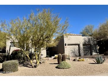 Single-story home with desert landscaping and two-car garage at 11060 E Mark Ln, Scottsdale, AZ 85262