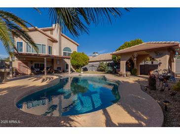 Inviting backyard pool with expansive patio and covered structure at 1313 W Glenmere Dr, Chandler, AZ 85224