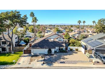 Aerial view of a house with a pool and backyard patio, surrounded by other homes at 13232 N 54Th Dr, Glendale, AZ 85304