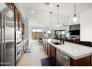 Modern kitchen with stainless steel appliances and marble countertops at 16328 E Ridgeline Dr, Fountain Hills, AZ 85268