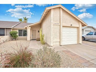 Charming home features desert landscaping, a two-car garage, and a welcoming entrance at 1638 E Sandra Ter, Phoenix, AZ 85022