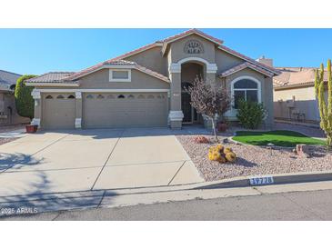 Single-story house with a two-car garage and landscaped front yard at 19778 N Coyote Lakes Pkwy, Surprise, AZ 85378