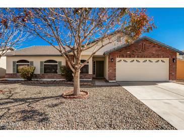 Brick home with a two-car garage and landscaped front yard at 2193 S Tucana Ln, Gilbert, AZ 85295