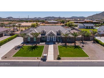 Luxury home with a large front yard, three-car garage, and a stunning view of the surrounding area at 21987 E Stacey Rd, Queen Creek, AZ 85142