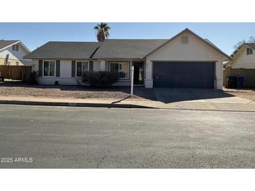 Single-story home with attached garage and mature landscaping at 2429 E Calypso Ave, Mesa, AZ 85204