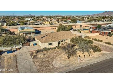 Aerial view of single-story home with detached shop, large yard, and paved driveway at 2602 S 226Th Dr, Buckeye, AZ 85326