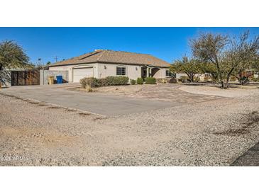 Single-story home with a large front yard, driveway, and walkway at 2602 S 226Th Dr, Buckeye, AZ 85326