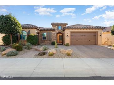 Single-story home with desert landscaping, two-car garage, and neutral color palette at 26783 W Piute Ave, Buckeye, AZ 85396