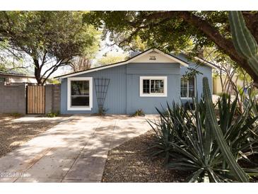 Charming bungalow with a light blue exterior, landscaped yard, and a spacious driveway at 3715 N 9Th Pl, Phoenix, AZ 85014