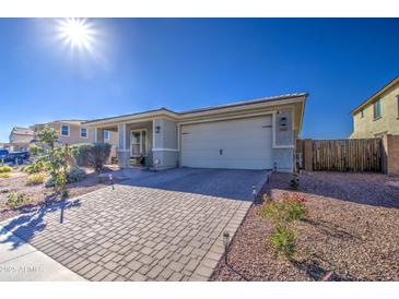 Single-story home with a two-car garage and landscaped front yard at 3740 S 182Nd Ln, Goodyear, AZ 85338