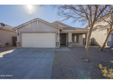 Single-story house with a two-car garage and desert landscaping at 44865 W Horse Mesa Rd, Maricopa, AZ 85139