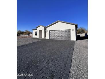 Modern single-story house with gray paver driveway at 8306 W Swansea Dr, Arizona City, AZ 85123