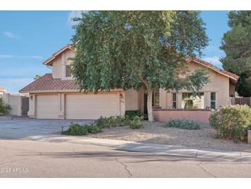 Beautiful two-story home with a three-car garage and mature landscaping at 1071 E Seminole Dr, Phoenix, AZ 85022