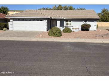 Single story home with a two-car garage and well-manicured landscaping at 10840 E Keats Ave, Mesa, AZ 85209