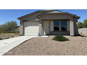 Newly built single-story home with attached garage and landscaped front yard at 14652 S Avalon Rd, Arizona City, AZ 85123