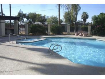 Community pool with a spa and surrounding patio at 2121 W Union Hills Dr # 115, Phoenix, AZ 85027