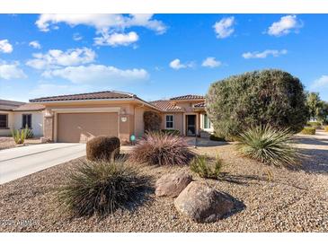 Single-story home with landscaped front yard and two-car garage at 21364 N Redington Point Dr, Surprise, AZ 85387