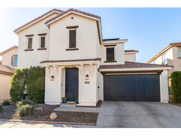 Two-story home with dark gray garage door and landscaping at 3170 S Nebraska St, Chandler, AZ 85248