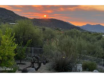 Stunning sunset over desert landscape, visible from property at 37202 N Holiday Ln, Carefree, AZ 85377