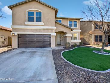 Two-story house with a brown door and attached garage, and a landscaped front yard at 12037 W Via Del Sol Ct, Sun City, AZ 85373