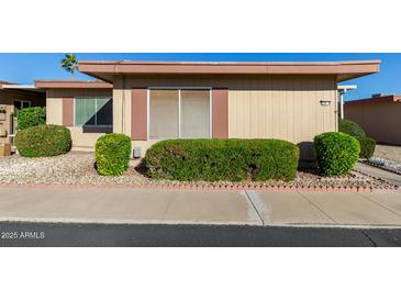 Tan single story home with manicured hedges at 13232 N 98Th Ave # N, Sun City, AZ 85351