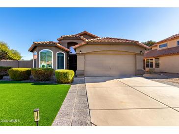 Single-story home with a two-car garage and well-maintained landscaping at 15415 S 37Th Pl, Phoenix, AZ 85044