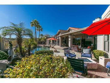 Inviting backyard with sparkling pool, patio furniture, and fire pit at 15959 E Brodiea Dr, Fountain Hills, AZ 85268