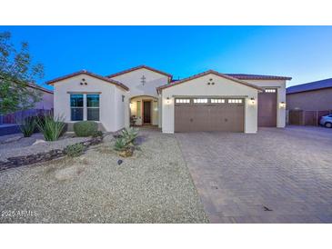 Stunning curb appeal! This home features a 3-car garage and desert landscaping at 16871 W Cielo Grande Ave, Surprise, AZ 85387