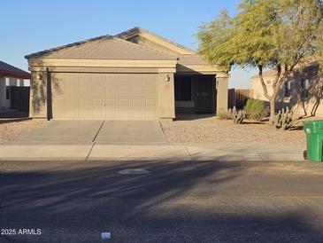 Single-story house with a two-car garage and desert landscaping at 19002 N Toledo Ave, Maricopa, AZ 85138