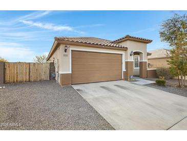 House exterior featuring a two-car garage and desert landscaping at 19137 W Jackson St, Buckeye, AZ 85326