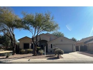 One-story house with a two-car garage and mature landscaping at 20457 N 80Th Dr, Peoria, AZ 85382