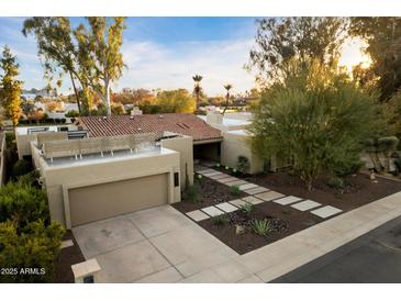 Aerial view of a single-story home with a tile roof, landscaped yard, and a two-car garage at 2423 E Marshall Ave, Phoenix, AZ 85016